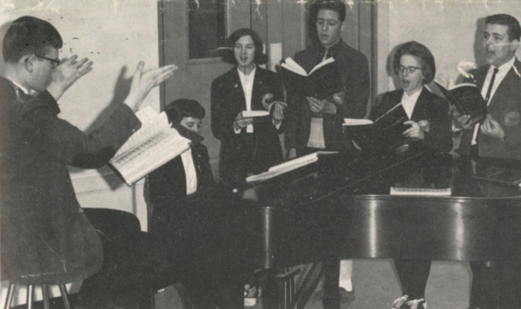 From Chronicle: "Directing Glee club members in preparation for the production of "Brigadoon," May 29 and 30, is Theodore Piekos accompanied by Carol Horr, pianist. Rita Arsenault, William Gotha, Marilyn Quill, and William Griffin are singing in the play.